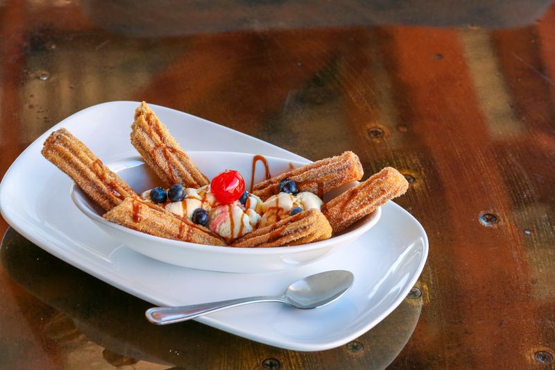 Cinnamon sticks dessert with sweet icing dip