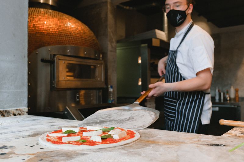 Jet's pizza team members working together in Denver kitchen